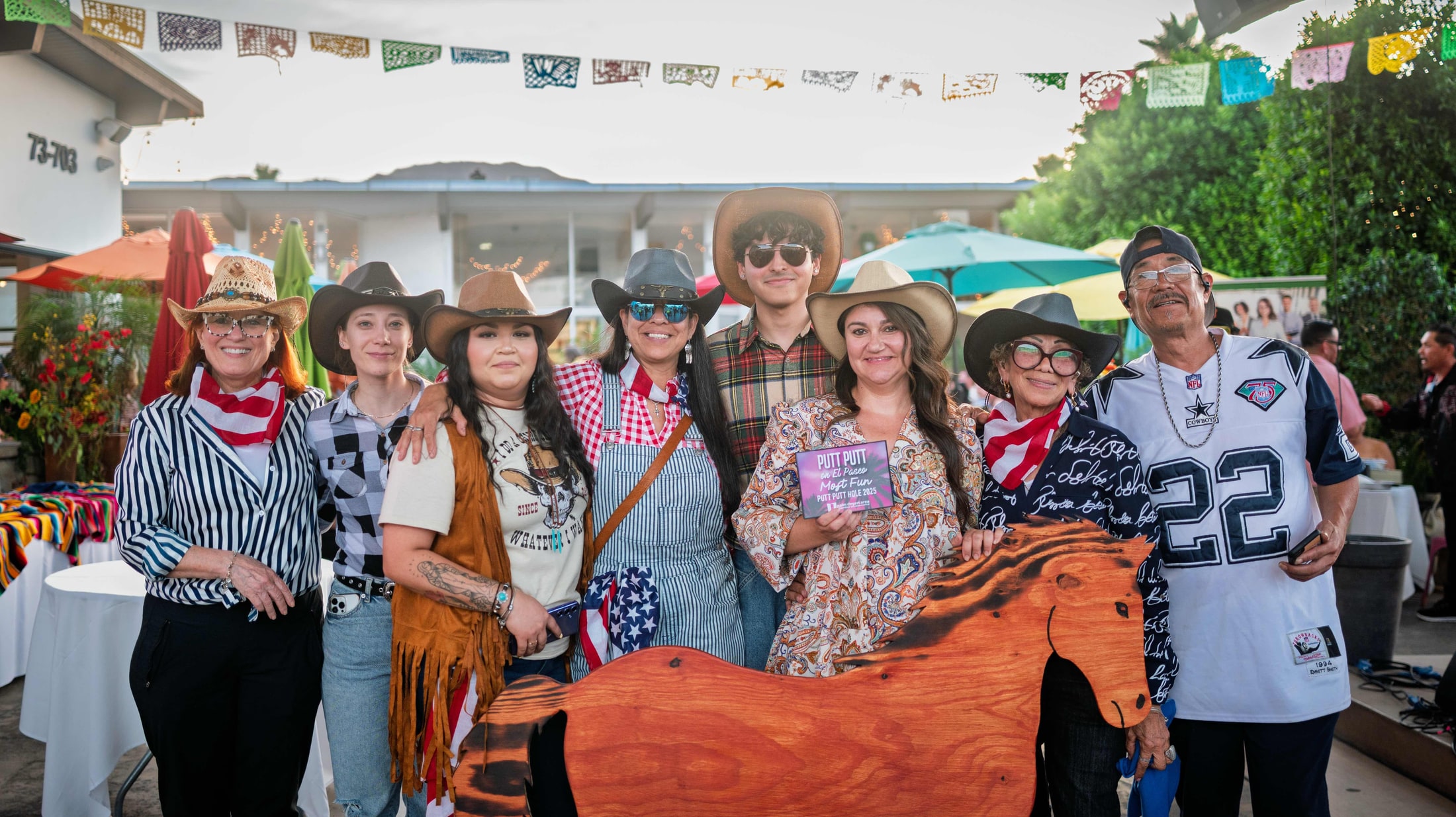 Family posing at a western-themed community event