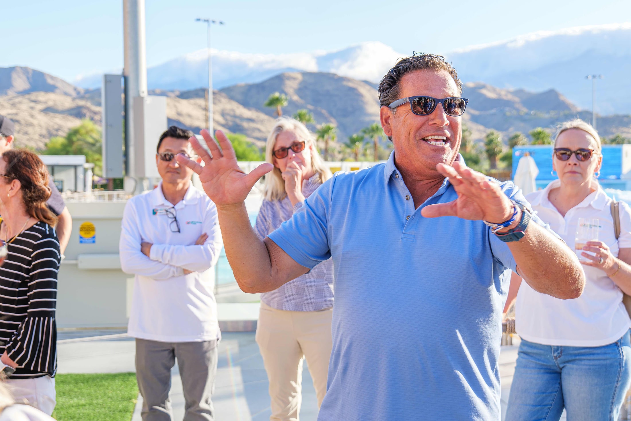 Guest celebrating with snow-capped mountains in the background
