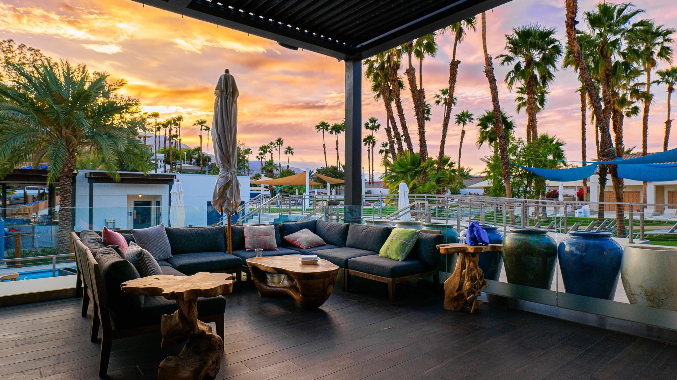 Desert lounge patio under a colorful sunset sky