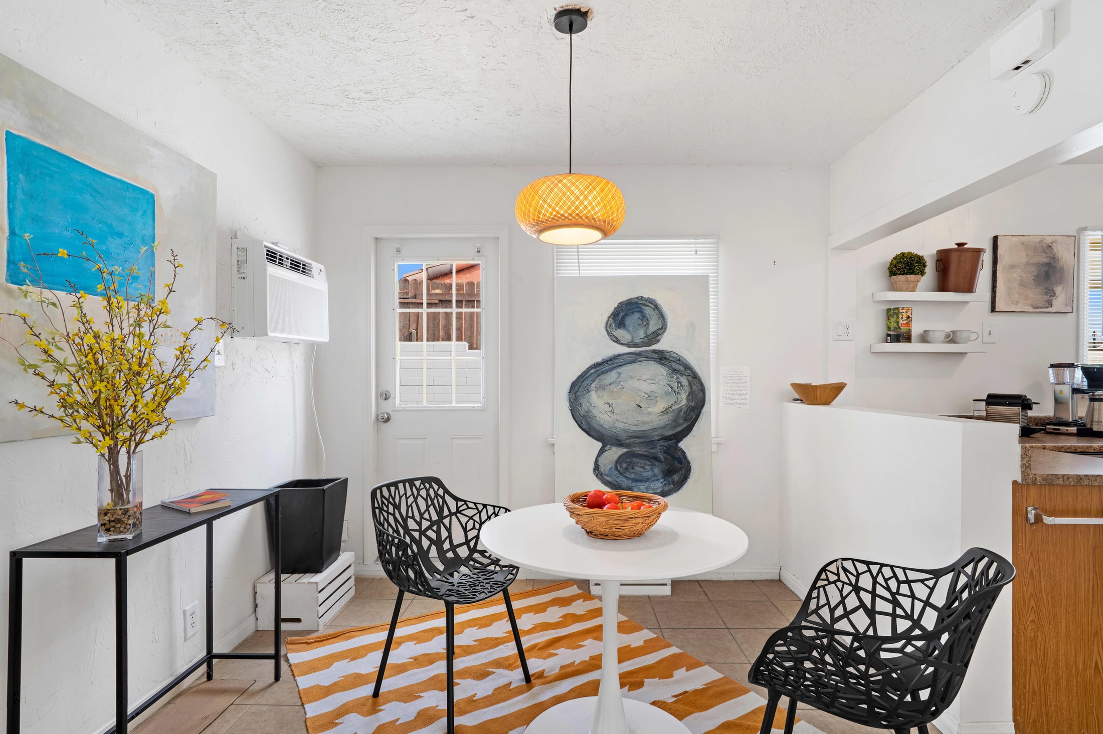 Breakfast nook with round table and striped rug
