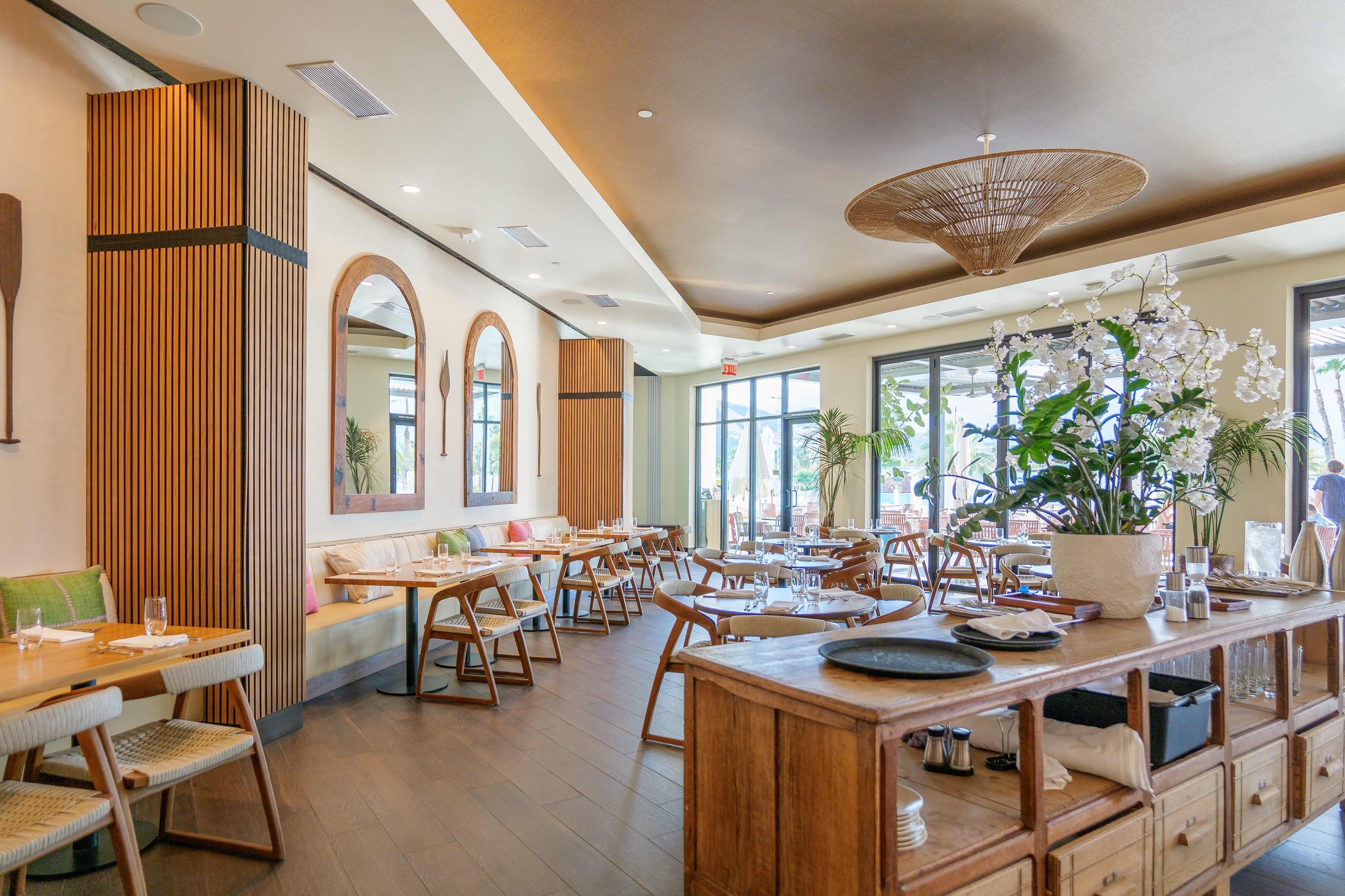 Resort dining room with wood ceiling and arched mirrors