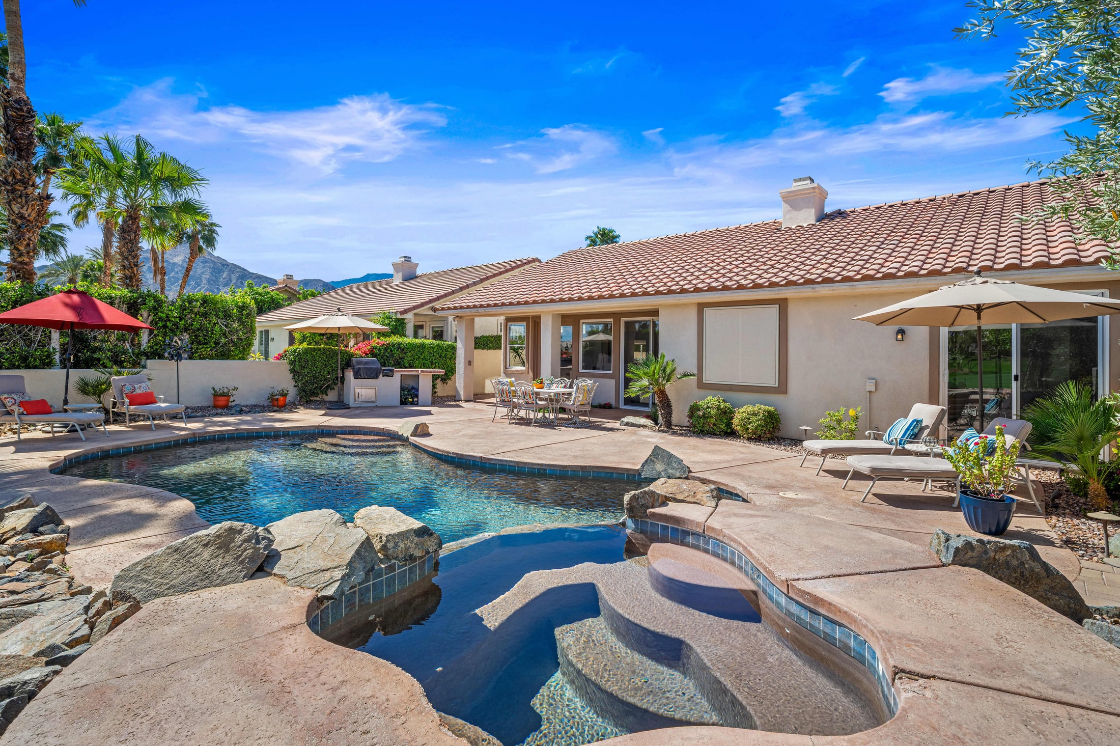 Backyard pool with mountain views in late afternoon light